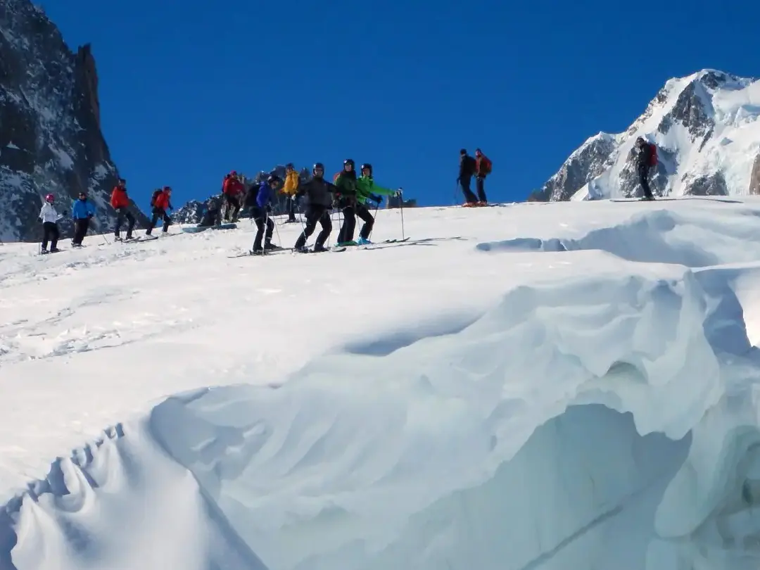 Skiers above a crevasse on the Vallée Blanche ski descent in Chamonix